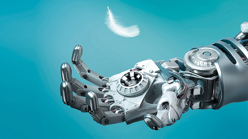 Beispielbild zum Megatrend Technologiewandel: Eine Roboterhand versucht, eine Gänsefeder zu fangen, die langsam nach unten schwebt. © GettyImages
